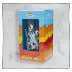 Beavertown Lazer Crush pint glass inside an orange and blue box in front of a grey background. Box has artwork depicting a white UFO in an orange, yellow and red canyon with a blue sky. Lazer Crush pint glass is visible in middle of box and is clear glass with white skeletons with black horns.