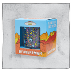 Beavertown Psychedelic tumbler glass inside an orange and blue box in front of a grey background. Box has artwork depicting a white UFO in an orange, yellow and red canyon with a blue sky. Psychedelic tumbler glass is visible in middle of box and is clear glass with colourful skulls and bones scattered all around the glass.