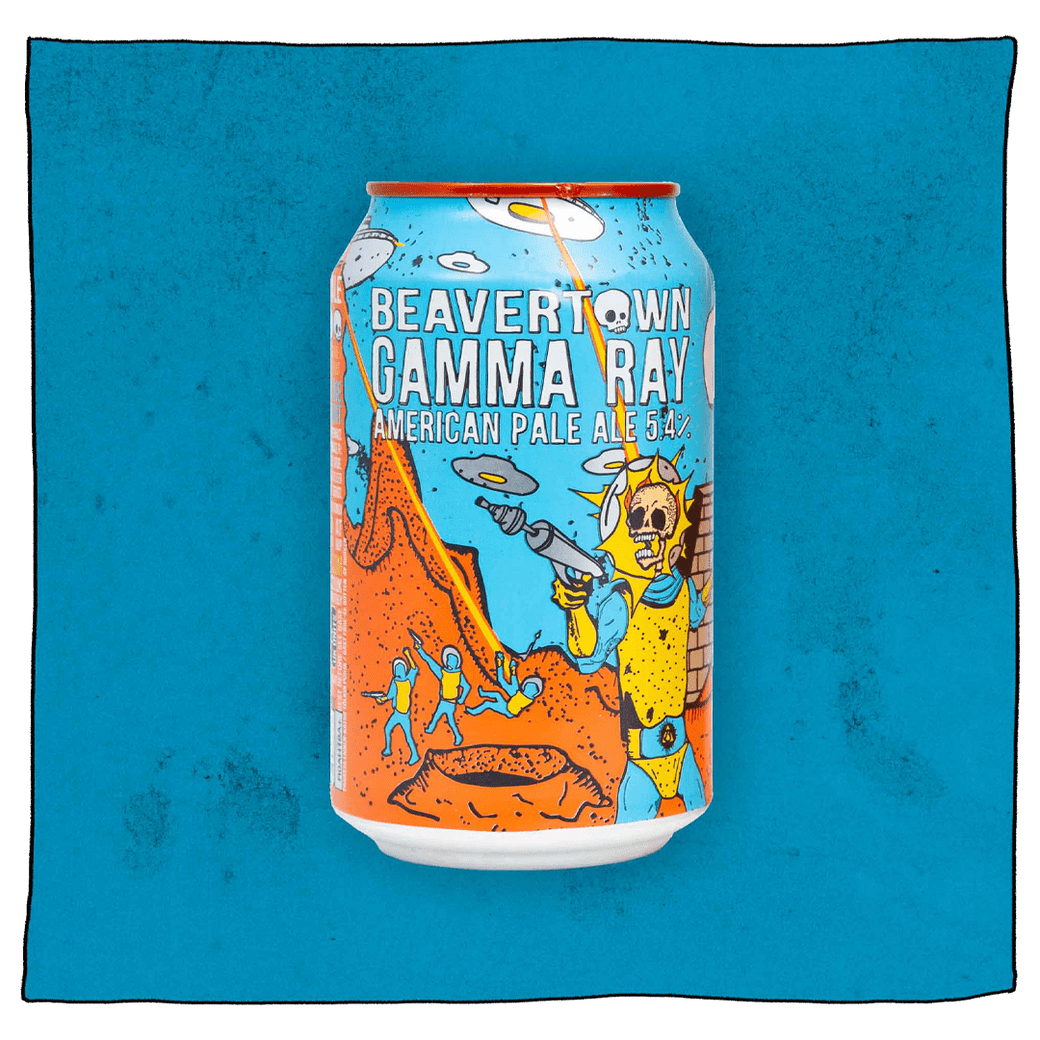 Beavertown Brewery Gamma Ray American Pale Ale in a blue, orange and yellow can in front of a blue and blotched dark blue background. Can has a yellow and blue astronaut skeleton with a grey ray gun in the foreground and orange craters, grey UFOs and other yellow and blue astronauts in the background.