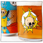 Zoomed in image of Beavertown Gamma Ray Tumbler Glass filled with beer next to a Gamma Ray American Pale Ale can. Tumbler Glass has skull inside a space helmet with yellow sparks around it.