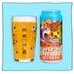 Heavy Gravity Hazy IPA and Psychedelic Pint glass filled with beer in front of a blue background. Can is blue with colourful meteors, a white skull and a silver UFO.
