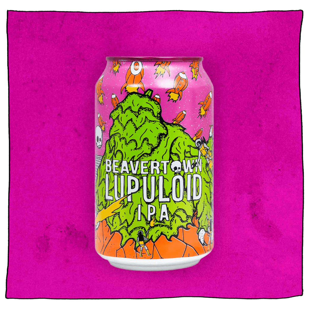 Beavertown Brewery Lupuloid IPA in a purple, green and orange can in front of a purple background. Can has a green furry monster in the foreground and many small orange rocketships around the top of the can.
