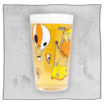 Neck Oil pint glass filled with beer in front of a light grey background. Glass has many orange and white skull hot air balloons.